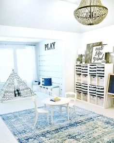 a living room filled with furniture and a blue rug on top of a wooden floor