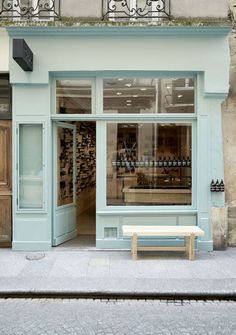 an empty bench in front of a store