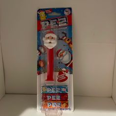 a toy toothbrush with a santa clause on it's head in a package