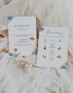 two wedding programs on top of a bed with white ruffles and blue flowers