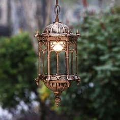 an old fashioned birdcage hanging from a chain with a light bulb on it