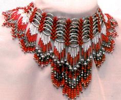 a red and silver beaded necklace on a mannequin