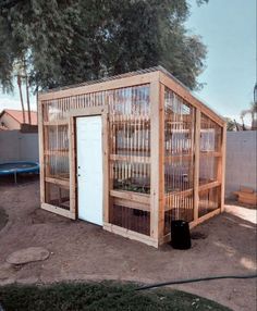 a small wooden building sitting in the middle of a yard