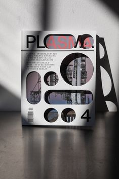 the cover of plasma magazine on a table with shadows coming from it and an image of a bridge in the background