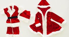 a red and white santa claus outfit next to its matching onesuit on a white surface