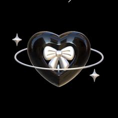 a heart shaped object with a bow on it's side and stars around it