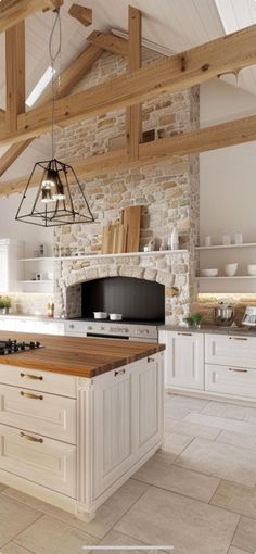 a large kitchen with an island in the middle and stone walls on both sides, along with wooden beams