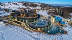 an aerial view of a ski resort in the winter with lots of snow on the ground