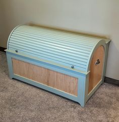 a blue and wooden bench sitting on top of carpeted floor next to a wall