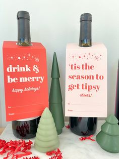 three wine bottles with christmas decorations around them and a sign that says drink & be merry