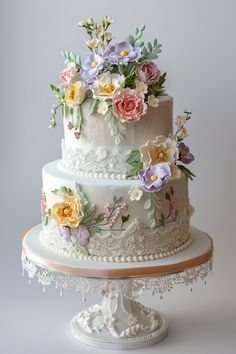 a three tiered cake with flowers on it