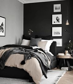 a black and white bedroom with pictures on the wall