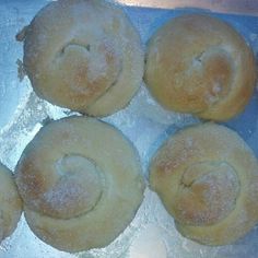 four doughnuts sitting on top of an aluminum pan