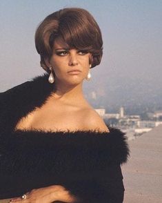 an image of a woman that is sitting on the roof with her arms crossed and looking off to the side