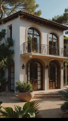 a large white house with lots of windows and balconies