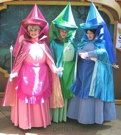 three women dressed in costumes standing next to each other