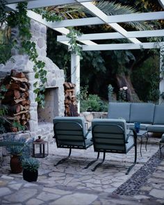 an outdoor living area with chairs and tables