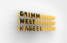 the word germ, weltt, kassel is spelled in black and yellow letters