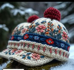 a knitted hat sitting on top of snow covered ground