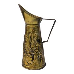 an old brass pitcher with a woman and child on it's side, against a white background