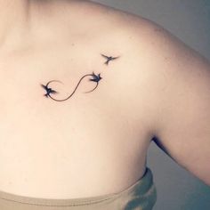 a woman's chest with three birds flying in the air on her left side