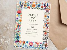 an image of a wedding card with flowers and leaves on the front, in bright colors