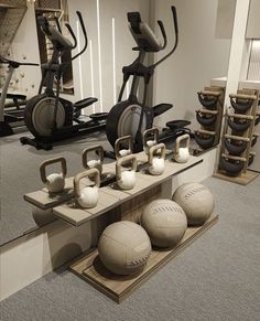 there are many balls and exercise equipment in the room with mirrors on the wall behind them