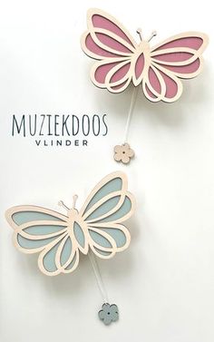 two paper butterflies on top of each other with the words mutzekdoos behind them