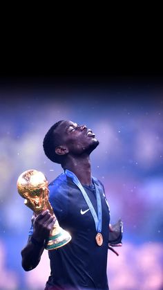 a man holding a golden trophy in his right hand and looking up at the sky