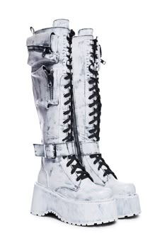 will have you winning every battle. These knee high combat boots have a vegan leather construction, heeled platform soles, zippered pockets on the sides, buckle strap details, adjustable lace-ups, and side zip closures. Grunge Knee-high Platform Boots For Concerts, Alternative Knee-high Platform Boots For Concerts, Alternative Style Knee-high Moto Boots, Knee-high Alternative Moto Boots, Edgy Knee-high Platform Combat Boots, Grunge Leather Knee-high Platform Boots, Alternative Knee-high Combat Boots For Streetwear, Grunge Knee-high Leather Platform Boots, Knee-high Grunge Boots For Streetwear