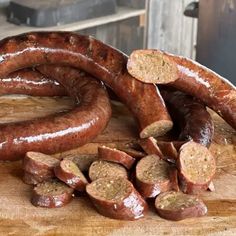 several sausages on a wooden cutting board