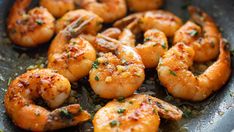 cooked shrimp in a skillet with herbs and seasoning on the side, ready to be eaten