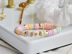 Pastel Heishi Bead Bracelet of Friendship Love type, ideal gift for Mother's Day or even a matchy matchy mother daughter look. With its tangy and soft colors, it will be an essential accessory for the summer. With its elastic thread, it will be perfectly adaptable to your wrist, a pretty minimalist jewel! It's a great gift for children too, little girls will be very proud of it! 1 x Bracelet : 12€ * Details Handcrafted Polymer clay Heishi bead Made in France, in my Breton workshop Please indicat Bracelet Perme Plate, Perle Heishi Bracelet, Bracelet Perles Heishi, Bracelet Perle Plate, Perle Heishi, Pulseras Aesthetic, Bracelet Heishi, Perle Plate, Heishi Jewelry