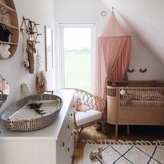 a baby's room with a crib, dresser and bed in the corner