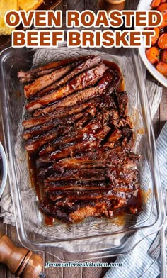 oven roasted beef brisket in a glass dish with bbq sauce on the side