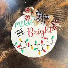 a merry and bright ornament hanging on a table