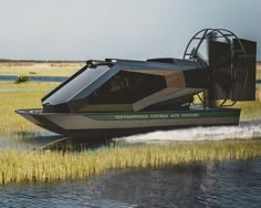 a small boat traveling across a body of water on top of dry grass covered ground