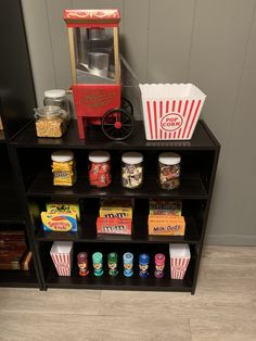 a shelf filled with different types of food on top of a wooden floor next to a wall