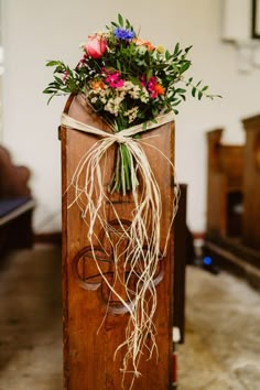 a bouquet of flowers sitting on top of a wooden box