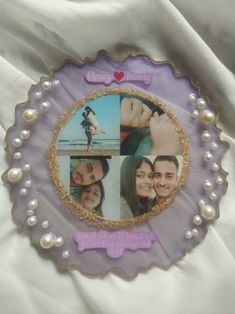 a purple and gold plate with pictures of two people on it, one is holding a woman's head