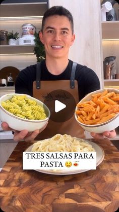 a man holding two bowls filled with pasta