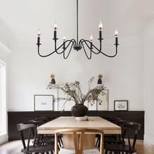 a dining room table with chairs and a chandelier hanging from the ceiling above it