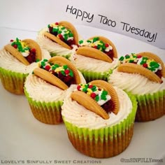 six cupcakes with frosting and decorations on them sitting on a white plate