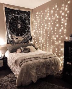 a bedroom with lights on the wall and a large tapestry hanging over the headboard