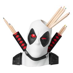 a white mask with red eyes and two sticks sticking out of it