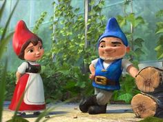 two gnomes standing next to each other in front of some logs and plants on the ground