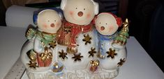 three ceramic figurines sitting on top of a table