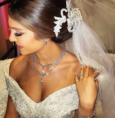 a woman wearing a wedding dress and jewelry