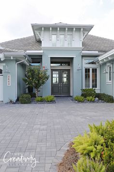 the front entrance to a house with landscaping