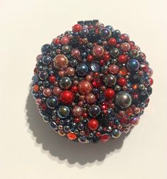 a colorful beaded object sitting on top of a white table